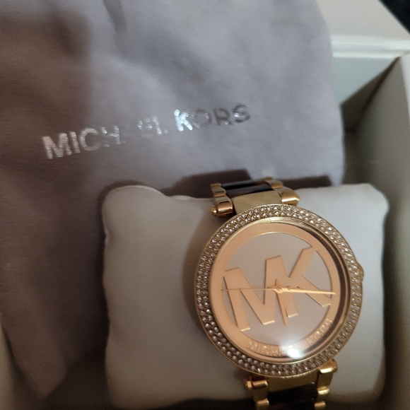 Micheal Kors gold tone watch with tourtise band